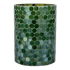 a green vase with lots of circles on it