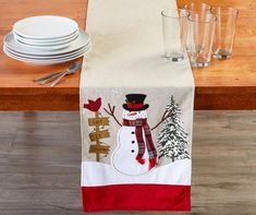 a christmas table runner with a snowman on it