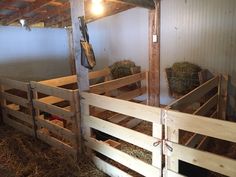 the inside of a barn with hay in it