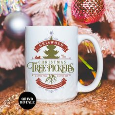 a white coffee mug with the words griswold christmas tree pickers on it