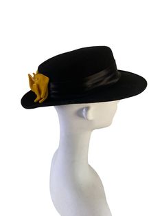 "For your consideration is a ladies vintage 100% wool hat in a bolero style with a Spanish flat top featuring a flattering double gold/yellow rear bow making a striking presentation. It's fashioned in pure wool felt, and embellished with a black satin band. It's flat brim can offer a bit of shade from the suns rays. Made in the USA and marked WPL 6823. Estimated circa:  1950's  Unmarked for size. I would estimate this hat to be a Women's size L Measures: Flat Top Crown: 2 3/4\"  high Brim: 2 3/4\" in length Inside opening measures 7 1/2\" front to back and 6 3/4\" side to side Condition - - near to excellent vintage shape:  I noticed one minor imperfection on the satin band, a very tiny mark that is not very noticeable depending on the lighting (see sixth photo) - this hat may have had a c Fitted Wool Hat Bands For Winter, Wool Hat Bands For Winter, Winter Wool Hat Bands, Fitted Brimmed Top Hat For Fall, Fitted Hat For Formal Winter Occasions, Fall Fitted Brimmed Felt Hat, Fitted Curved Brim Top Hat For Fall, Fitted Wool Top Hat For Fall, Fitted Top Hat With Curved Brim For Fall