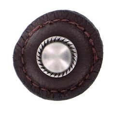 a close up of a leather button on a white background