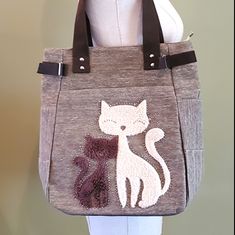 This Bag Is In Excellent Condition. 2 Shaggy Cats Surrounded By A Little Bling! The Material Is A Heavier Weight A Little Like A Jean Material. Large Zipper Area On Back. Large Zippered Pocket On Front Too Behind Cats. 15 Inches Tall X 12 Inches Wide At The Bottom And About 9.5 Inches On Top X 4 Wide. Cute Brown Bag For Daily Use, Cute Brown Bags For Daily Use, Cute Brown Everyday Shoulder Bag, Beige Bag With Cat Design For Everyday Use, Beige Bags With Animal Design For Everyday Use, Cute Brown Tote Bag, Beige Cat Design Bag For Everyday Use, Everyday Beige Bag With Cat Design, Cute Bags With Animal Design For Everyday Use