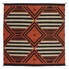 an orange, black and white rug with geometric designs on it's edges is shown