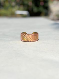 This vintage 70's mixed metal modern cuff bracelet features a striking combination of copper and gold tones. Adorned with abstract decorations, it embodies a boho style that adds a touch of eclectic elegance to any outfit. Its unique design and retro charm make it a perfect statement piece for those who appreciate distinctive, timeless accessories. inner size: 2-1/4 x 2 inches; opening 1-1/4 inches; 1-3/8 inches tall; good condition with some minor fine scratches and stains.  ---------Shipments Artistic Gold Copper Bracelets, Artsy Adjustable Gold Bracelets, Artsy Adjustable Gold Bracelet, Adjustable Artsy Gold Bracelet, Artisan Gold Cuff Bracelet In Copper, Gold Copper Cuff Bracelet, Unique Gold Copper Cuff Bracelet, Unique Gold Cuff Bracelet In Copper, Bohemian Gold Cuff Bracelet In Copper