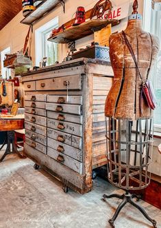 an old dresser with lots of drawers and mannequins on it's sides