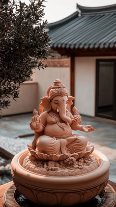 an elephant statue sitting on top of a fountain