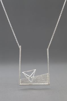 Transforming Triangle Necklace by Zhenwei Chu. Finding endless inspiration in geometric shapes, the artist lends the necklace depth with three-dimensional forms and hammered texture. The entire necklace is made with sterling silver. The chain can be adjusted to 20, 22 or 24. Modern Necklace With Rectangular Pendant And Box Chain, Modern Necklace With Silver Chain And Rectangular Pendant, Modern Jewelry With Rectangular Pendant And Silver Chain, Modern Sterling Silver Necklace With Square Pendant, Modern Sterling Silver Square Pendant Necklace, Modern Silver Chain Pendant Necklace, Contemporary Sterling Silver Necklace With Large Pendant, Modern Sterling Silver Necklace With Silver Chain, Contemporary Sterling Silver Necklaces