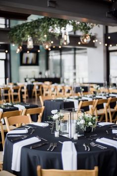 the tables are set with black and white linens