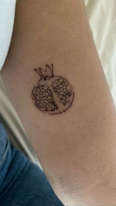 a small tattoo on the arm of a woman