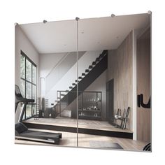 an exercise room with treadmills and glass doors leading to the second floor area