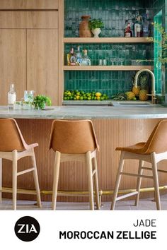 A wooden bar is met with tan leather stools as a green zellige backsplash showcases glassware and citrus fruits. Roof Tiles Design, Tommy Bahama Kitchen, Zia Tile, Moroccan Architecture, Tiles Design, Roof Tiles, Kitchen Tile, Tiny Kitchen, Architecture And Design