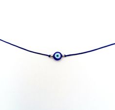 Navy blue evil eye cord necklace with gold or silver beads. The evil eye is used to protect the person that wears it from the malevolent look of others who envy or dislike that person. The necklace is made with 1mm black waxed string,and has a 8mm blue glass evil eye bead. It is adorned on each side with gold or silver beads. Total length: 80cm / 31 inches It is adjustable to fit a lot of sizes. Custom orders for different colour combinations are welcome. Other necklaces in my shop: https://www. Adjustable Evil Eye Amulet Necklace, Adjustable Spiritual Evil Eye Necklace, Simple Short Necklace, Dainty Choker, Blue Evil Eye, Colour Combinations, Short Necklace, Cord Necklace, Fun Earrings