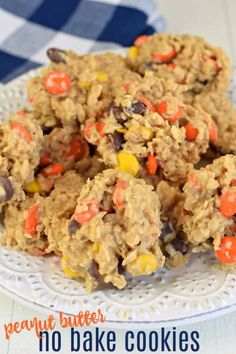 peanut butter no bake cookies on a white plate with candy cornflakes and chocolate chips