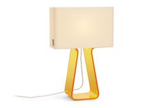 a yellow lamp with a white shade on it's side and a cord attached to the