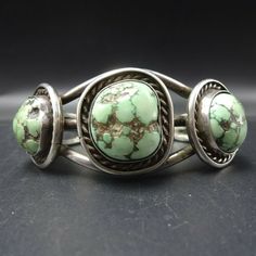 "VINTAGE NAVAJO BRACELET DESCRIPTION: Three gorgeous specimens of Dry Creek turquoise set in heavy gauge vintage sterling silver, this bracelet will be a cherished addition to your collection of fine vintage Native American jewelry. MEASUREMENTS: Interior of the cuff measures 4 7/8\" with an additional 1 1/2\" slightly adjustable gap. Total circumference: \" Measures 2 1/4\" straight across the widest part (from wrist bone to wrist bone) Bracelet face measures 1 1/8\" wide (the face of the brace Vintage Green Sterling Silver Cuff Bracelet, Vintage Handmade Turquoise Sterling Silver Bracelet, Vintage Turquoise Sterling Silver Bracelets, Handmade Vintage Turquoise Sterling Silver Bracelet, Vintage Adjustable Turquoise Sterling Silver Bracelet, Vintage Sterling Silver Nickel-free Bangle, Nickel Free Sterling Silver Vintage Bangle, Vintage Sterling Silver Collectible Bangle, Vintage Turquoise Round Cuff Bracelet