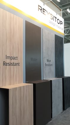 an exhibit booth with several different types of counter tops and signs on the wall that say impact resistant