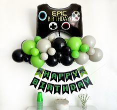 an image of a birthday party decoration with balloons and streamers in the shape of a video game controller