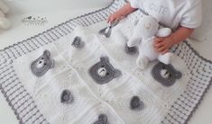 a baby is holding a teddy bear on a crocheted blanket in the shape of a square