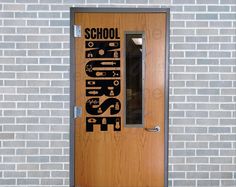 a door with the words school and tools on it in front of a brick wall