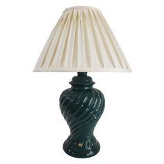 a green table lamp with a white shade on the base and a beige pleated lampshade