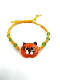 * Handcrafted glass orange cat bracelet, designed and created with love. Elegant, cute handmade glass garfield bracelet . Bright, beautiful, comfortable to wear with both elegant and trendy clothes. Eye-catching, very pretty  glass cat bracelets. Each jewel is specifically designed for women and kids.   * If you like this beautiful green eyes cat bracelet, feel free to go to our Etsy Shop to see the rest our products: https://www.etsy.com/uk/shop/TheGlassUniverse  * More Bracelets: https://www.etsy.com/uk/shop/TheGlassUniverse?section_id=32730569 * High wearing comfort! All bracelets are highly sustainable as the are made of high-quality materials.  *  Individually handcrafted glass orange cat bracelet made with love out of handmade glass. Each jewel is absolutely unique  and customizable. Beaded Cat, Beautiful Green Eyes, Cat Tee Shirts, Garfield Cat, Cat Bracelet, Cat Bead, Beaded Jewels, Bracelet Beaded, Orange Cat