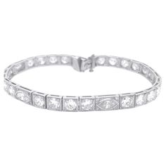 Step into the glamour of the Art Deco era with this exquisite Period Art Deco Diamond Bracelet, adorned with a dazzling display of 8.00 carats of G color, VS clarity marquise and round cut diamonds elegantly set in platinum. The geometric patterns and intricate detailing of this bracelet exude the essence of Art Deco design, making it a true statement piece for those who appreciate the elegance of vintage luxury. Each diamond, with its brilliant G color and VS Clarity, radiates brilliance and sophistication, capturing the spirit of a bygone era. Crafted with precision and artistry, this bracelet is a testament to the timeless beauty and glamour of Art Deco style. Elevate your ensemble with this stunning Period Art Deco Diamond Bracelet, a showcase of refined taste and opulent allure that t Luxury Vintage Bracelet With Brilliant Cut, Period Art, Bygone Era, Art Deco Diamond, Art Deco Era, Art Deco Design, Tennis Bracelet, Geometric Patterns, Round Cut Diamond