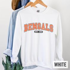 Bengals Crewneck Sweatshirt, Cincinnati Bengals Sweatshirt, Women's Bengals Football Sweatshirt, Bengals Fan Gifts, Cincinnati Bengals Football Gifts, Bengals Sweatshirt for Women, Bengals Crewneck for Her, Cute Cincinnati Bengals Sweatshirt This super comfy crewneck is unisex so for women, make sure to size down for a more fitted look and go up 1-2 sizes for an oversized look. Colors may vary slightly from images based on the screen/monitor you are viewing them on. Sweatshirts are made to order, so please allow 2-5 days production time before your order ships (production times increase during the holidays). Thank you for supporting my small business! Gildan 18000 Crewneck Sweatshirt: .:Classic fit - air jet yarn for the softest comfortable feel and reduced pilling. .:50/50 preshunk cotton Bengals Crewneck, Bengals Sweatshirt, Cincinnati Bengals Football, Bengals Football, Comfy Crewneck, Football Gift, Football Sweatshirt, Sweat Shirts, Football Gifts