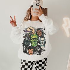 This Halloween Monster Shirt has a Vintage Halloween vibe and a fun Monster Mash themed graphic. Celebrate Spooky Season with a cute Fall sweatshirt that you will want to wear on repeat. This is a relaxed fit unisex sweatshirt, but true to size. We recommend sizing up if you want a trendy oversized look. - M A T E R I A L S - Gildan® Sweatshirt 8 oz./yd² (US) 50/50 cotton/polyester Heather Sport colors: 60/40 polyester/cotton Loose Fit Ribbed Knit Collar to retain shape - C A R E  I N S T R U C Halloween Themed Streetwear Tops, Themed Crew Neck Top For Costume Party, Themed Long Sleeve Tops With Cartoon Print, Themed Long Sleeve Top With Cartoon Print, Halloween Themed Crew Neck Tops, Halloween Themed Tops With Crew Neck, Themed Long Sleeve Sweatshirt With Character Print, Themed White Tops For Fall, Pop Culture Tops With Character Print For Fall