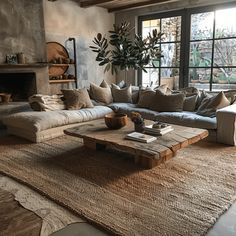 a living room filled with lots of furniture and a large rug on top of a wooden floor