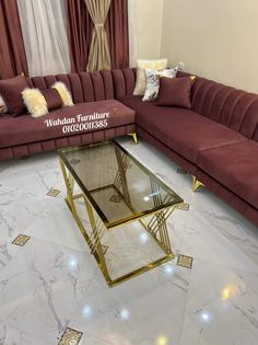 a living room with marble flooring and red couches in the center, surrounded by gold trimmings