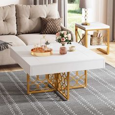 a white coffee table with gold accents in a living room area next to a beige couch