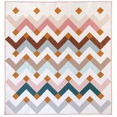 a multicolored chevron pattern quilt on a white background with an orange border