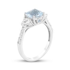 This glimmering aquamarine ring makes an unforgettable gift for your special occasion. Sterling silver A cushion-cut aquamarine is flanked by trillion-cut white lab-created sapphires Bezel-set round aquamarines shimmer on the sides of the setting Round-cut white lab-created sapphires line the tapered shank Aquamarine Three-stone Anniversary Rings, Aquamarine Three-stone Wedding Rings, Aquamarine Three Stone Wedding Rings, Three Stone Aquamarine Rings For Anniversary, Anniversary Three Stone Aquamarine Rings, Elegant Aquamarine Ring With Ethical Diamonds, Elegant White Aquamarine Rings, Aquamarine Diamond Ring With Accent Stones, Fine Aquamarine Diamond Ring With Accent Stones