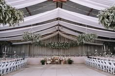 the inside of a tent with tables and chairs