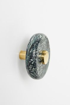 a close up of a door knob on a white wall with a gold plated handle