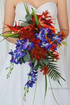 a bride holding a bouquet of red and blue flowers