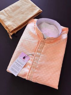 PLEASE NOTE - The Kurta does NOT come with Lining.  Designer Light Pastel Peach Kurta Self Embroidery. The neckline has beautiful  handwork done.  Very trendy and Classy Looking Mens Wear. Item : Men's Kurta Pajama Ready to Wear : Yes Kurta Color : Pastel Light Peach Color  Pajama Color : Gold Brown  Fabric :  Soft Silk  Pocket : Yes Work :  Fancy Buttons Lining : No  Disclaimer -For sizing please refer to the Size Chart given in the listing with the pictures. - Please do NOT go by the size of t Peach Kurta With Zari Work For Wedding, Festive Peach Cotton Sets, Peach Straight Kurta For Wedding, Traditional Kurta For Ceremony And Festivals, Cotton Sherwani With Chikankari Embroidery For Wedding, Unstitched Embroidered Traditional Wear For Ceremony, Orange Wedding Kurta For Eid, Peach Wedding Traditional Wear With Chikankari Embroidery, Pink Cotton Sherwani For Wedding