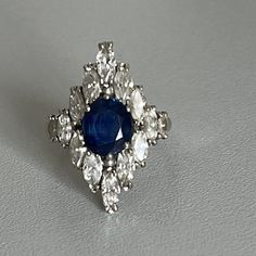 White gold ring (18k) centered with a faceted oval sapphire of pretty color in claw setting in an entourage of marquise diamonds. Total diamond weight: approximately 1.30 ct. Gross Weight: 6.05g. Size: 55 Possibility of resizing, contact us. Further information : We issue an invoice as well as a certificate of authenticity established by our qualified gemologist (LFG Paris). Our photos are not reworked and are taken in a natural light environment. We can send you a short video on request. Each j White Gold Sapphire, Claw Setting, Marquise Diamond, White Gold Ring, Multi Stone Ring, Multi Stone, Sapphire Diamond, Pretty Colours, Short Video