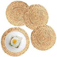 four round placemats with an egg in the middle and one plate on top