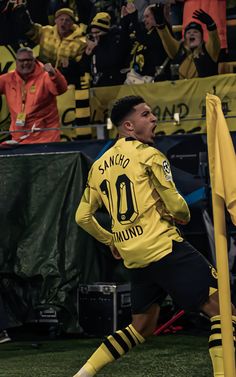 a man in yellow jersey kicking a soccer ball