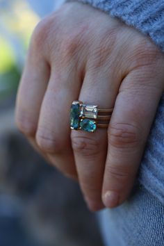 This waterfall of color is simple, classic and bold. You will be intrigued by all that it can do. Stack it with other colorful rings or wear it alone. Deco in feel, but super modern in taste. This 14k recycled gold stacking stone ring features a baguette cut blue tourmaline set in two-sided bezel. Pictured in:14k yellow gold1.26ct blue green tourmaline2mm wide Jennifer Dawes Design works with responsible diamantaires. Due to fluctuations in the diamond market, pricing varies on diamonds based on Emerald Cut Gemstone Stackable Rings In 14k Gold, Modern 14k White Gold Jewelry With Accent Stones, 14k White Gold Stackable Emerald Cut Rings, Modern 14k Gold Emerald Cut Birthstone Ring, Modern Multi-stone Emerald Cut Jewelry, Modern Yellow Gold Emerald Cut Stackable Rings, Stackable 14k Gold Emerald Ring For Everyday, Modern 14k Gold Emerald Cut Stackable Rings, Modern Stackable Emerald Cut 14k Gold Rings