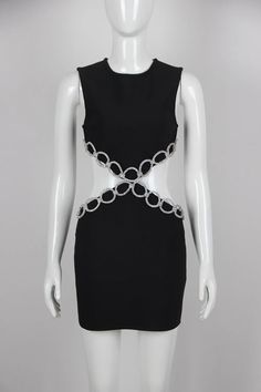 a mannequin wearing a black dress with chains on it