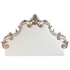 an ornate silver headboard with scrolls and flowers on the top, against a white background