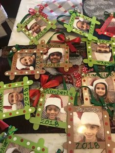 a table topped with lots of frames covered in christmas pictures and ribbons on top of it