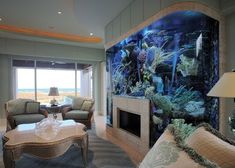 a living room filled with furniture and a large fish tank