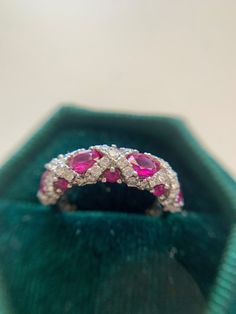 This beautiful ruby and Diamond ring is perfect for a stand alone band or stackable charm!  She is platinum.  4 oval rubies 4.5mm x 3.5mm approximately.  6 round rubies 2mm  53 brilliant cut natural diamonds 0.65 tcw. I color, VS1 clarity.  US size 5, sizable within reason. Luxury Heirloom Gia Certified Ruby Ring, Luxury Ruby Stackable Rings With Round Cut, Luxury Modern Ruby Ring As Gift, Dazzling Oval Ruby Ring, Luxury Marquise Cut Red Ruby Ring, Luxury Red Marquise Cut Ruby Ring, Oval Diamond Cut Ruby Ring, Dazzling Ruby Ring With Vvs Clarity, Ruby Ring With Diamond Cut