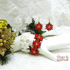 a white mannequin with red and gold decorations on it's head, sitting next to a christmas tree