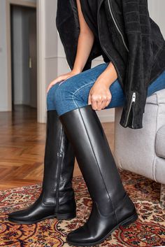 Is there a more classical pair of boots than riding boots? We know they will look very classy, no matter if you want to wear them with a pair of jeans and a t-shirt or a floral ruffle dress. The straight shape of the shaft and the 2,5 cm heel will give your legs a tapered look. Choose the calf circumference and height that best fit you, click the button above to get to know how to correctly measure your calf. Details: Fine calfskin upper Leather lining, leather insole Leather sole with a non-sli Classic Wide Calf Knee-high Boots For Riding, Elegant Wide Calf Riding Boots, Classic Black Calf Leather Knee-high Boots, Classic Winter Moto Boots In Calf Leather, Classic Leather Sole Knee-high Boots For Winter, Classic Knee-high Boots With Leather Sole For Winter, Classic Fitted Knee-high Boots With Leather Sole, Classic Winter Knee-high Boots With Leather Sole, Classic Riding Boots For Fall