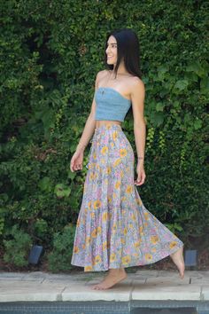 The Marjori skirt has an elastic waist with tassels to add a little boho charm. It has three layers into its design with and A shape. fabric: 100% cotton Vacation Tiered Maxi Skirt With Boho Print, Summer Boho Print Tiered Maxi Skirt, Vacation Boho Print Tiered Maxi Skirt, Boho Print Tiered Maxi Skirt For Vacation, Tiered Boho Print Maxi Skirt For Vacation, Flowy Cotton Maxi Skirt With Ruffles, Spring Bohemian Maxi Skirt With Elastic Waistband, Bohemian Tiered Skirt With Floral Print, Spring Festival Cotton Maxi Skirt